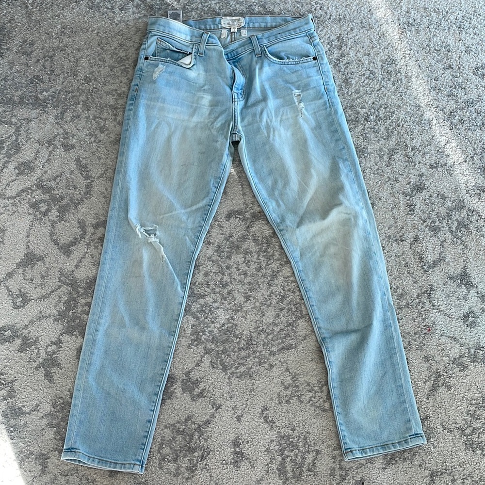 Light wash jeans. Distressed. Small light pink highlighter mark on back.